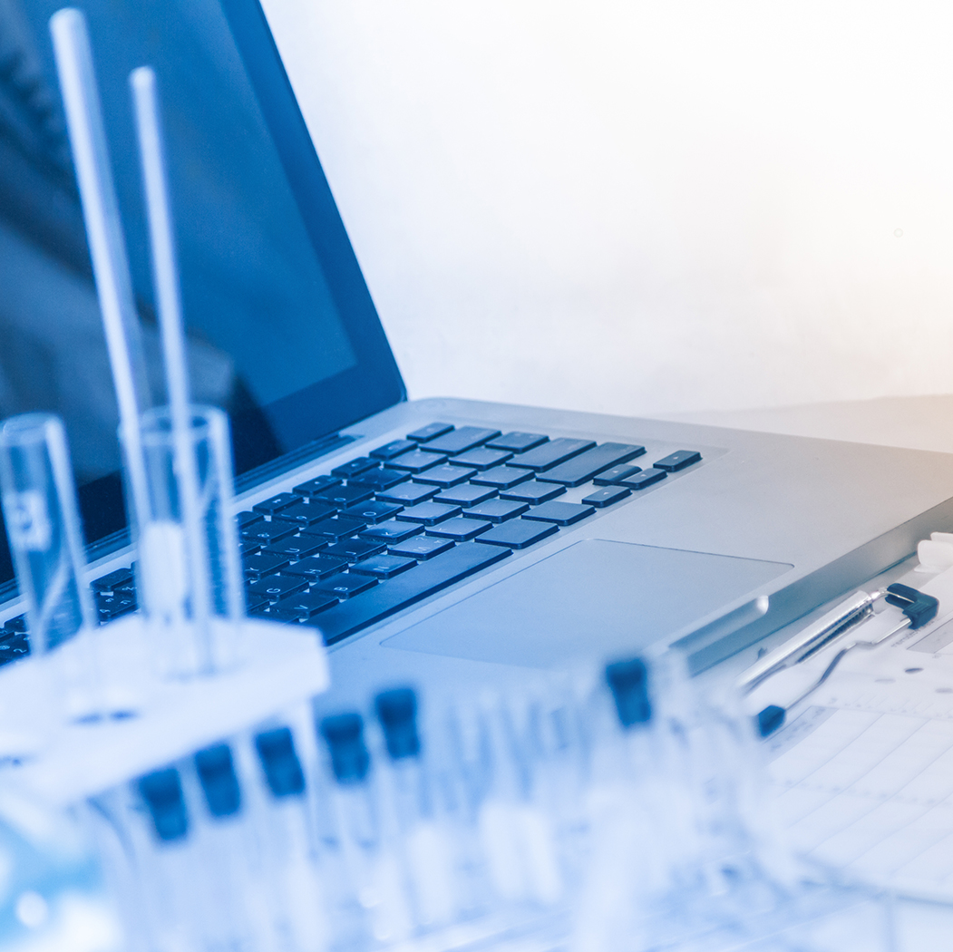 laptop and specimen bottles, Life Sciences | DXC Technology