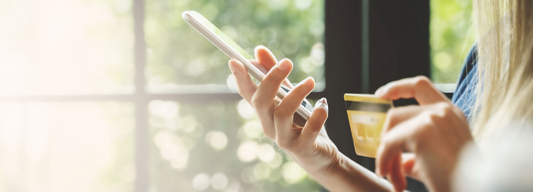 hands of woman holding credit card shopping on website, Banking BPS | DXC Technology