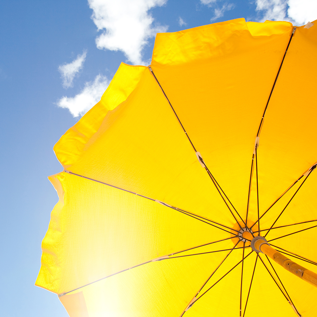 yellow beach umbrella in sunny sky, Insurance BPS | DXC Technology
