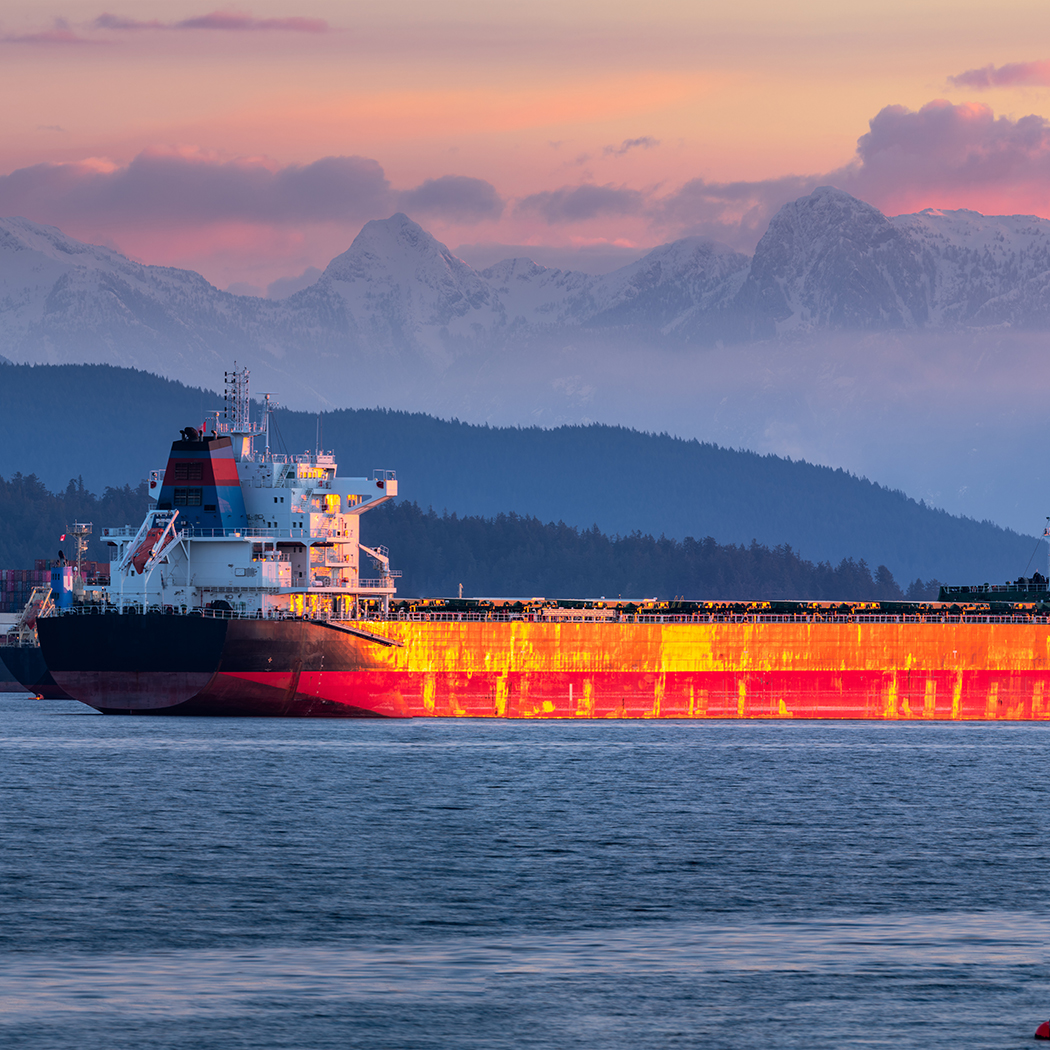 Large orange barge at sea, Assure Commercial and Specialty, Insurance Software | DXC Technology